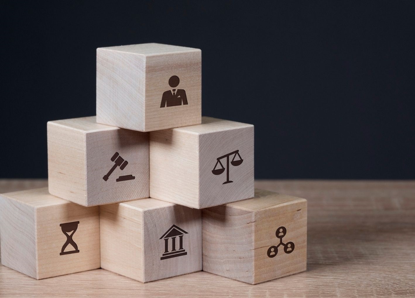 Wooden blocks with employment and legal icons