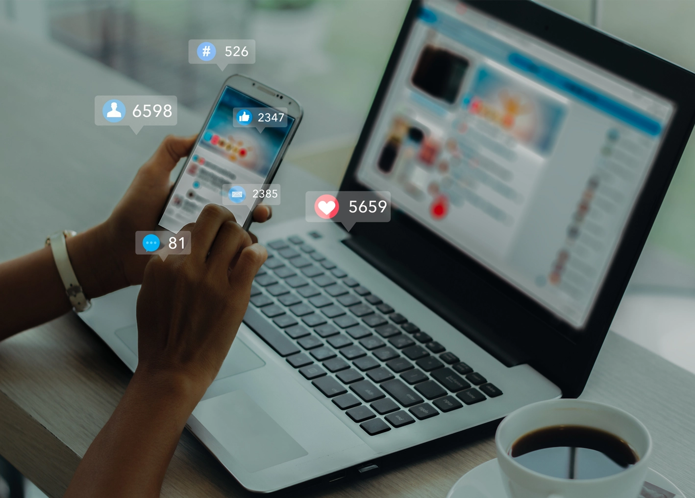 Social media icons displaying over smart phone and laptop