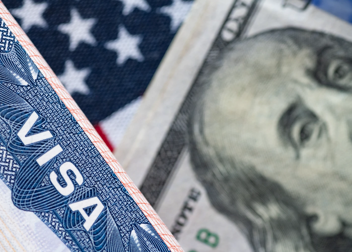 Hundred dollar bill and a visa on the background of the US flag