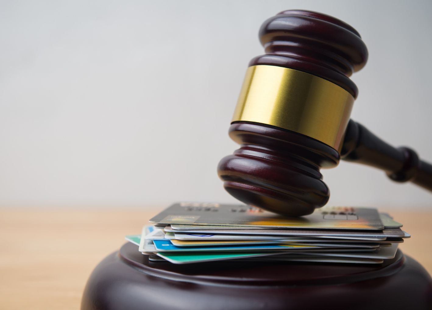 Gavel on top of credit cards