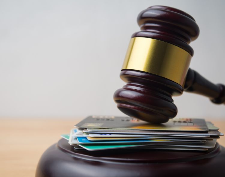 Gavel on top of credit cards