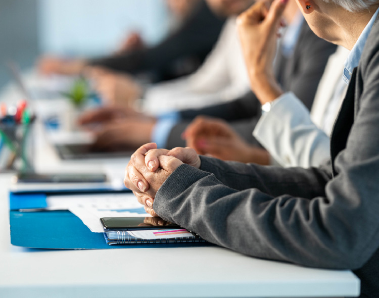 Close up of entrepreneur with clasped hands on a meeting